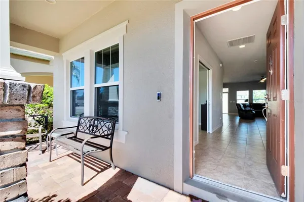 a living room with furniture and a floor to ceiling window