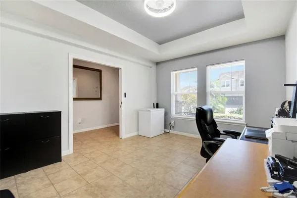 a view of a workspace with furniture and a window
