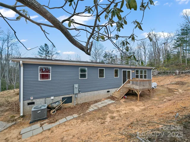 a view of a house with a yard and wooden fence