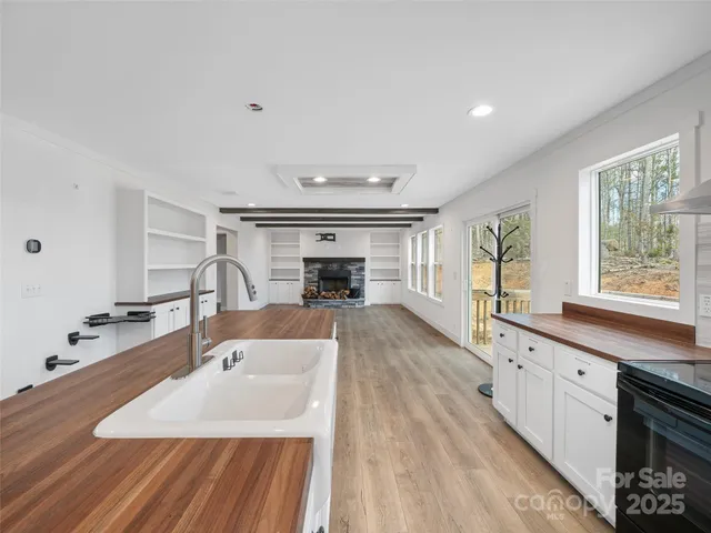 a large kitchen with kitchen island a sink stainless steel appliances and cabinets