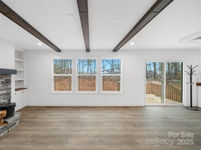 a view of an empty room with a window and workspace