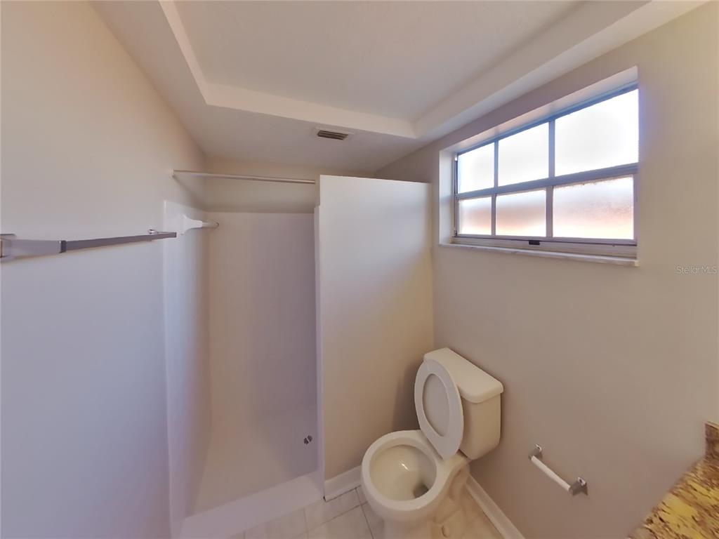 Undisclosed Address Holiday, FL 34691 - Photo 13 of 18 a bathroom with a toilet and a window