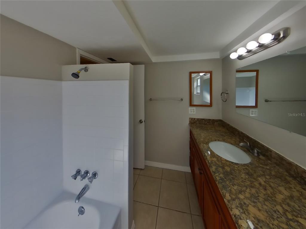 Undisclosed Address Holiday, FL 34691 - Photo 15 of 18 a bathroom with a granite countertop sink a toilet and shower