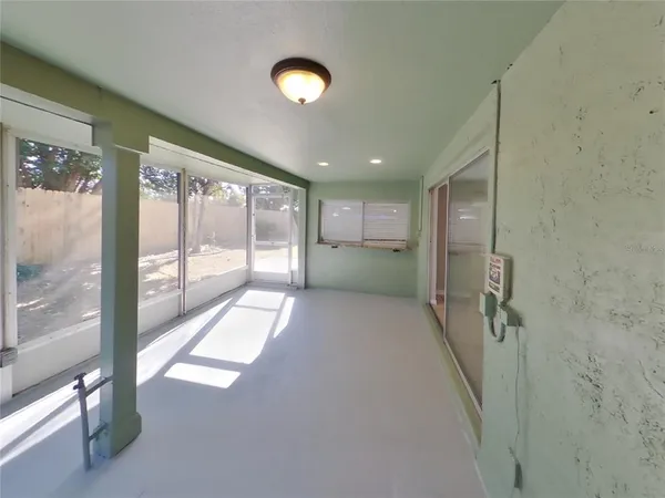 a view of hallway with stairs and a large window