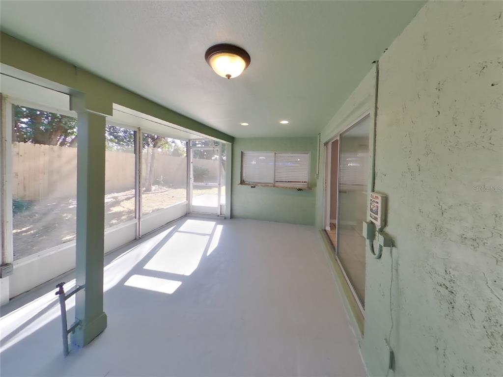 Undisclosed Address Holiday, FL 34691 - Photo 16 of 18 a view of hallway with stairs and a large window