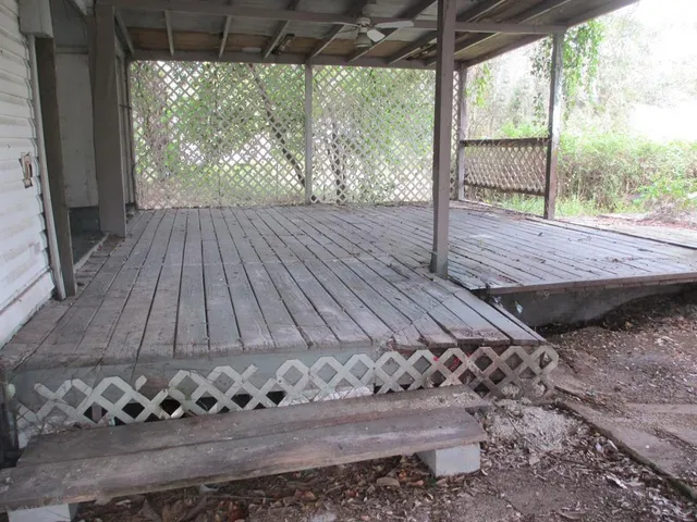 a view of a porch with wooden floor