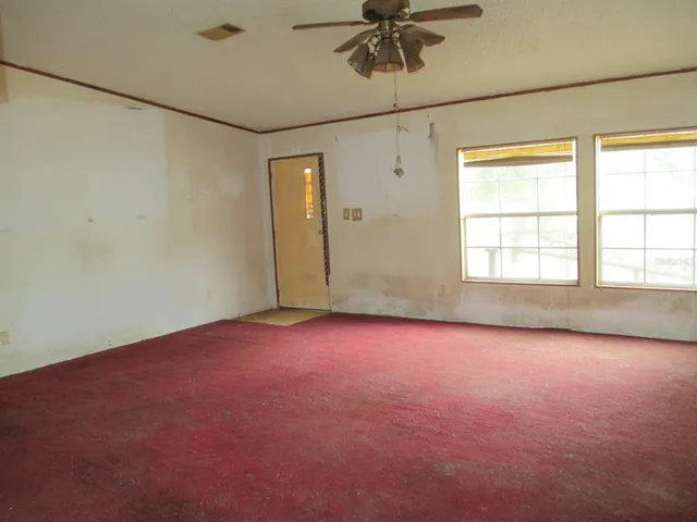 a kitchen with a sink a stove cabinets wooden floor and a window