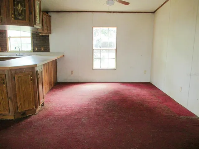 a kitchen with cabinets and window