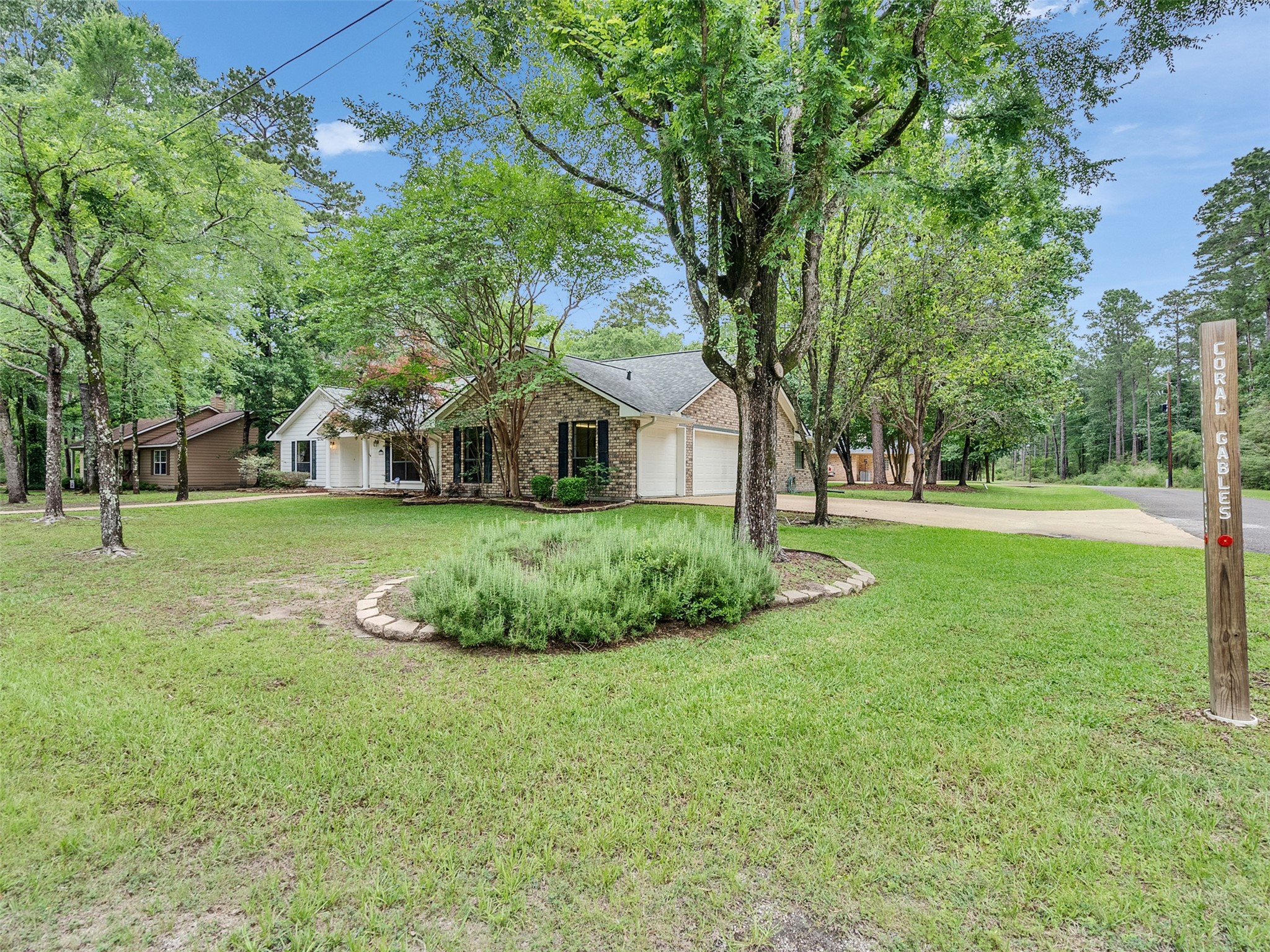 195 Coral Gables Trinity, TX 75862 - Photo 43 of 50 a view of a house with a big yard and large trees