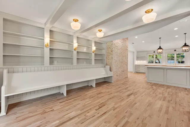 a view of a kitchen with wooden floor and cabinets