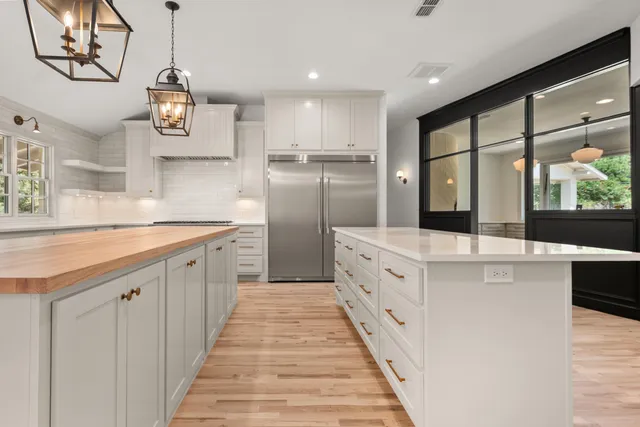 a large white kitchen with a large window