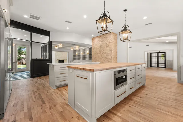 a kitchen with stainless steel appliances granite countertop a stove and cabinets