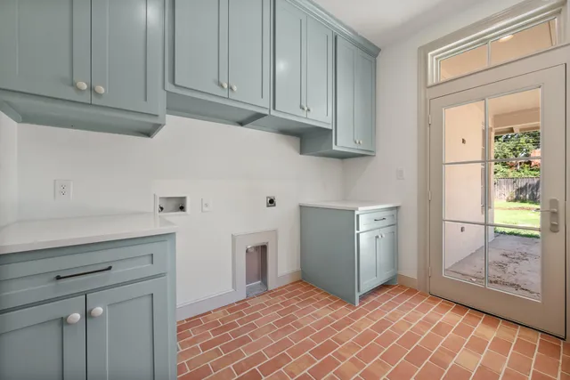 a kitchen with white cabinets and a sink