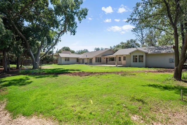 a front view of house with yard and green space