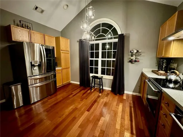 a kitchen with stainless steel appliances a stove a refrigerator and a sink