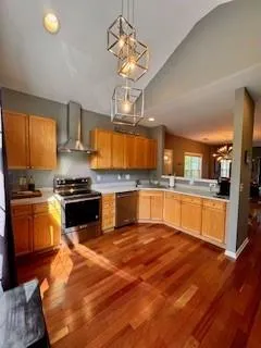 a large kitchen with granite countertop a stove top oven a sink a counter space and cabinets