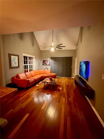 a bedroom with bed and wooden floor