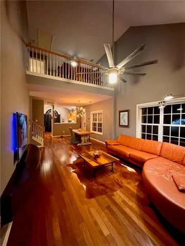 a living room with furniture a ceiling fan and a rug