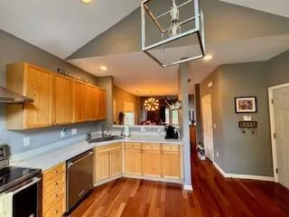 a kitchen with a sink window and refrigerator