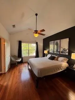 a bedroom with a large bed and a large window