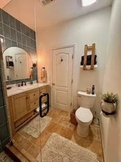 a bathroom with a sink toilet and a mirror