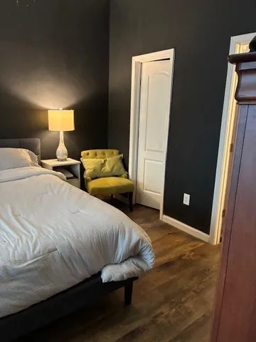 a bedroom with a bed and a mirror