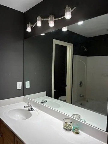 a bathroom with a sink a vanity and a mirror