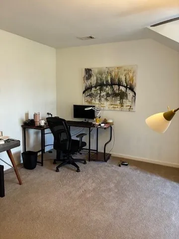 a workspace with furniture and window