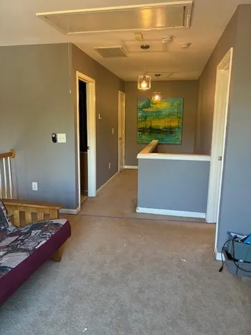 a view of a livingroom with furniture and a window