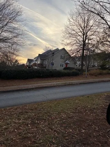 a view of house with backyard and trees