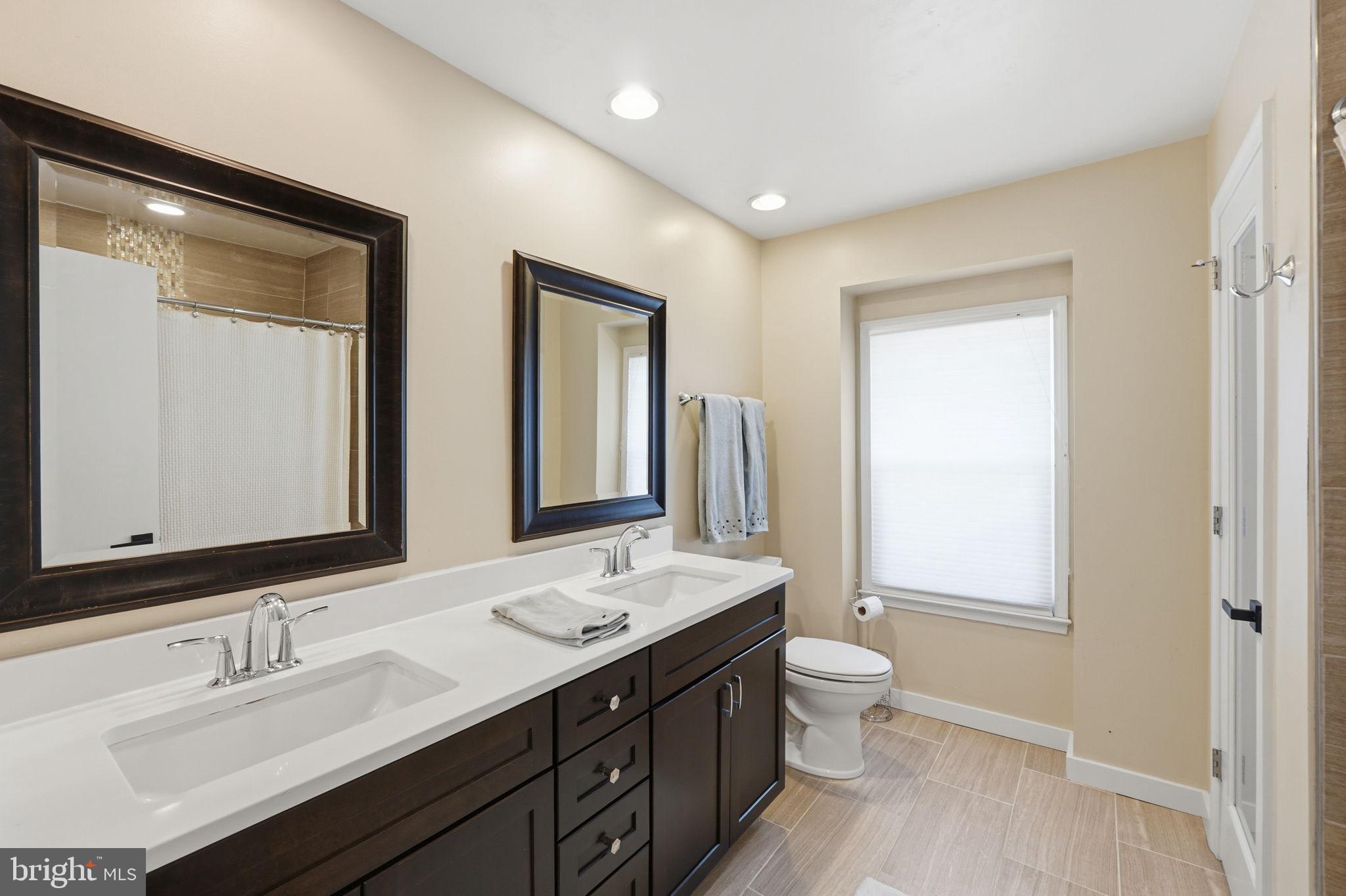 4205 Norbeck Road Rockville, MD 20853 - Photo 24 of 33 Elegant dual-sink bathroom retreat.