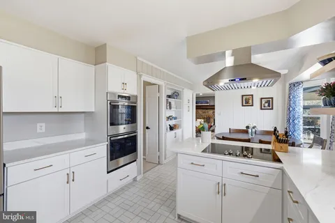 a kitchen with stainless steel appliances kitchen island granite countertop a refrigerator and a sink