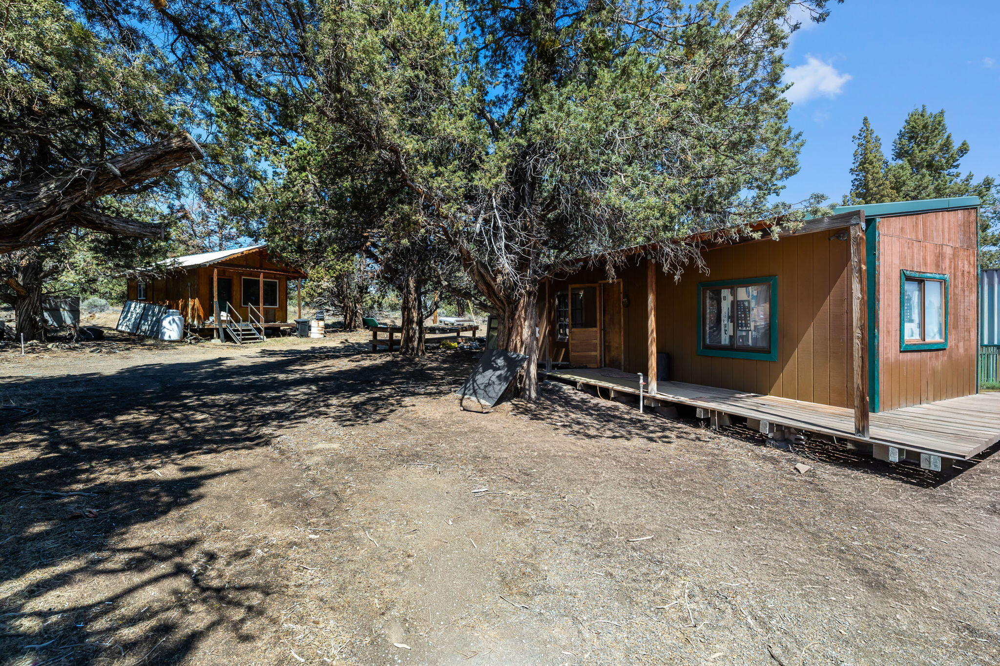 63639 Gentry Loop Bend, OR 97701 - Photo 38 of 40 a view of a barn with wooden wall and large trees