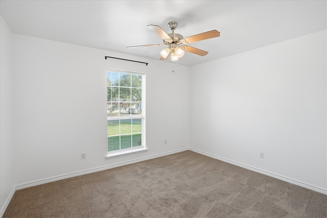 107 South 4th Street Odem, TX 78370 - Photo 20 of 29 an empty room with window and fan