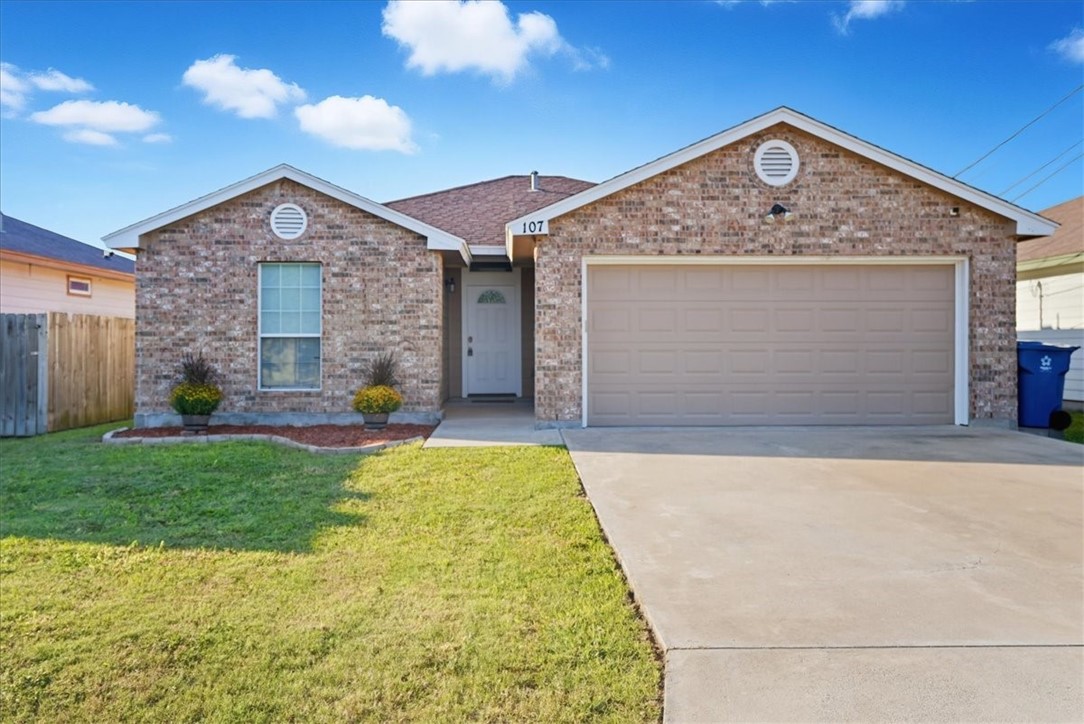 107 South 4th Street Odem, TX 78370 - Photo 2 of 29 a front view of a house with garden
