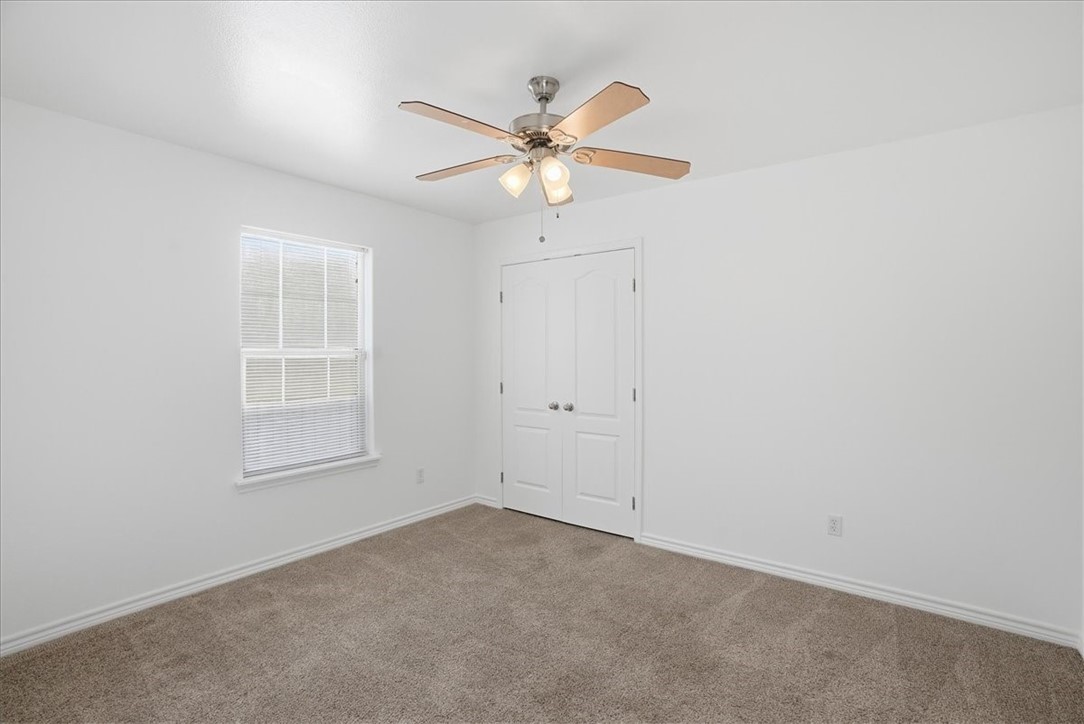 107 South 4th Street Odem, TX 78370 - Photo 23 of 29 an empty room with a window and a fan