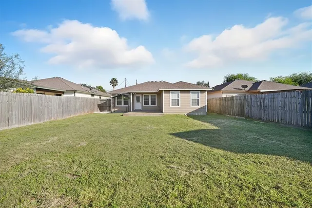a view of a house with a yard and sitting area