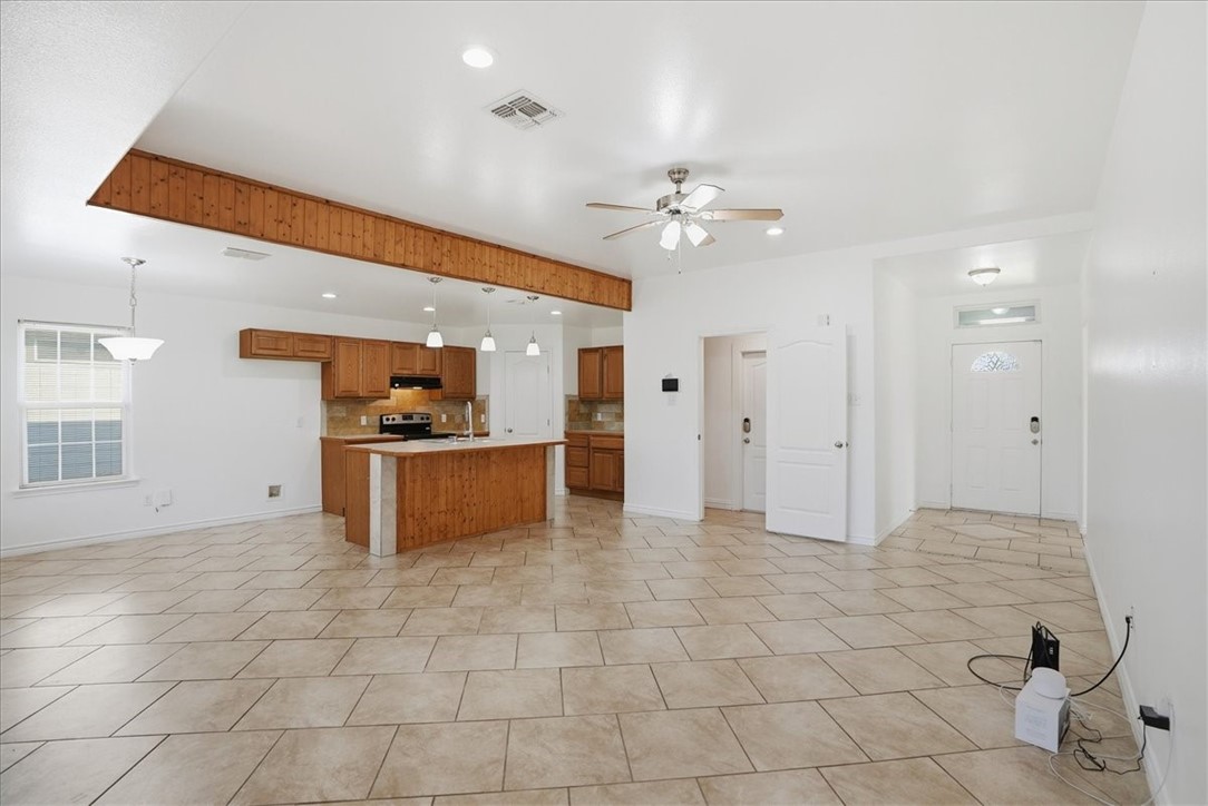 107 South 4th Street Odem, TX 78370 - Photo 7 of 29 a view of a kitchen with a sink and a refrigerator