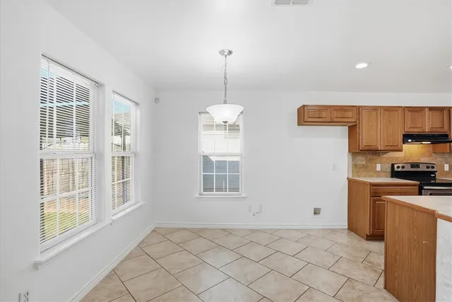 a view of a kitchen with windows