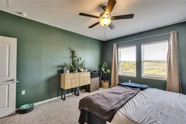 a bedroom that has a bed and a table in it