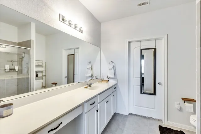 a bathroom with a double vanity sink a and mirror