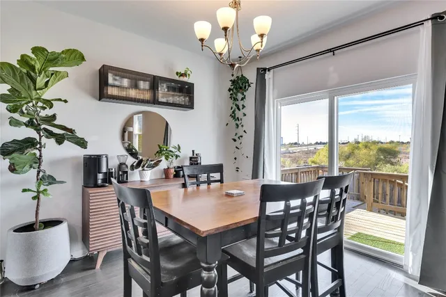 a view of a dining room with furniture a chandelier and wooden floor