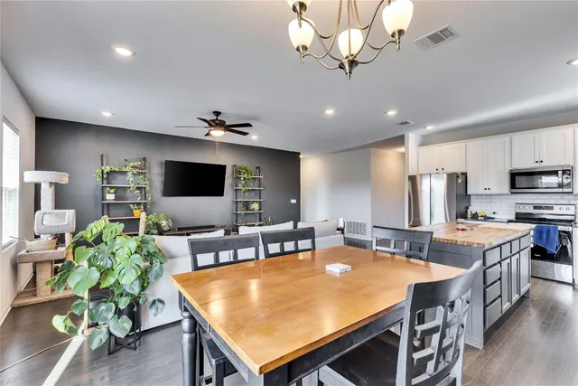 a large kitchen with a table and chairs