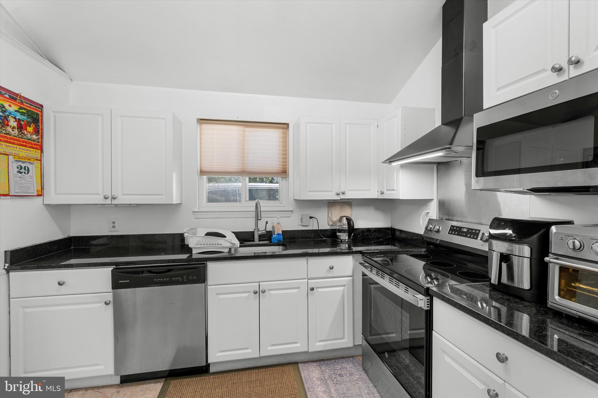 8304 Harland Drive Springfield, VA 22152 - Photo 16 of 39 a kitchen with stainless steel appliances granite countertop white cabinets sink and stove