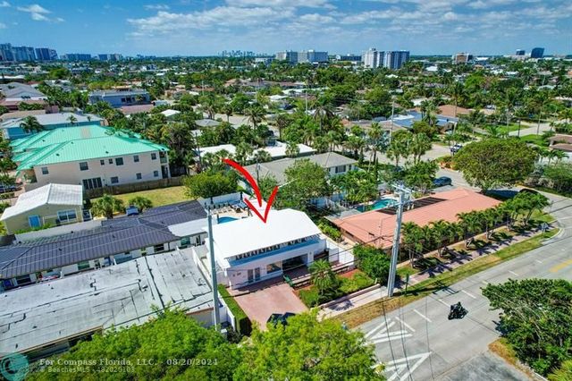 an aerial view of a houses with a city street view