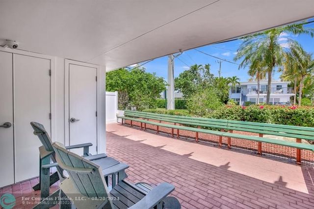 a view of a hallway to an empty room with a window