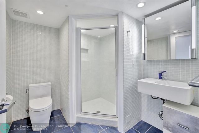 a kitchen with stainless steel appliances granite countertop a sink a stove and cabinets