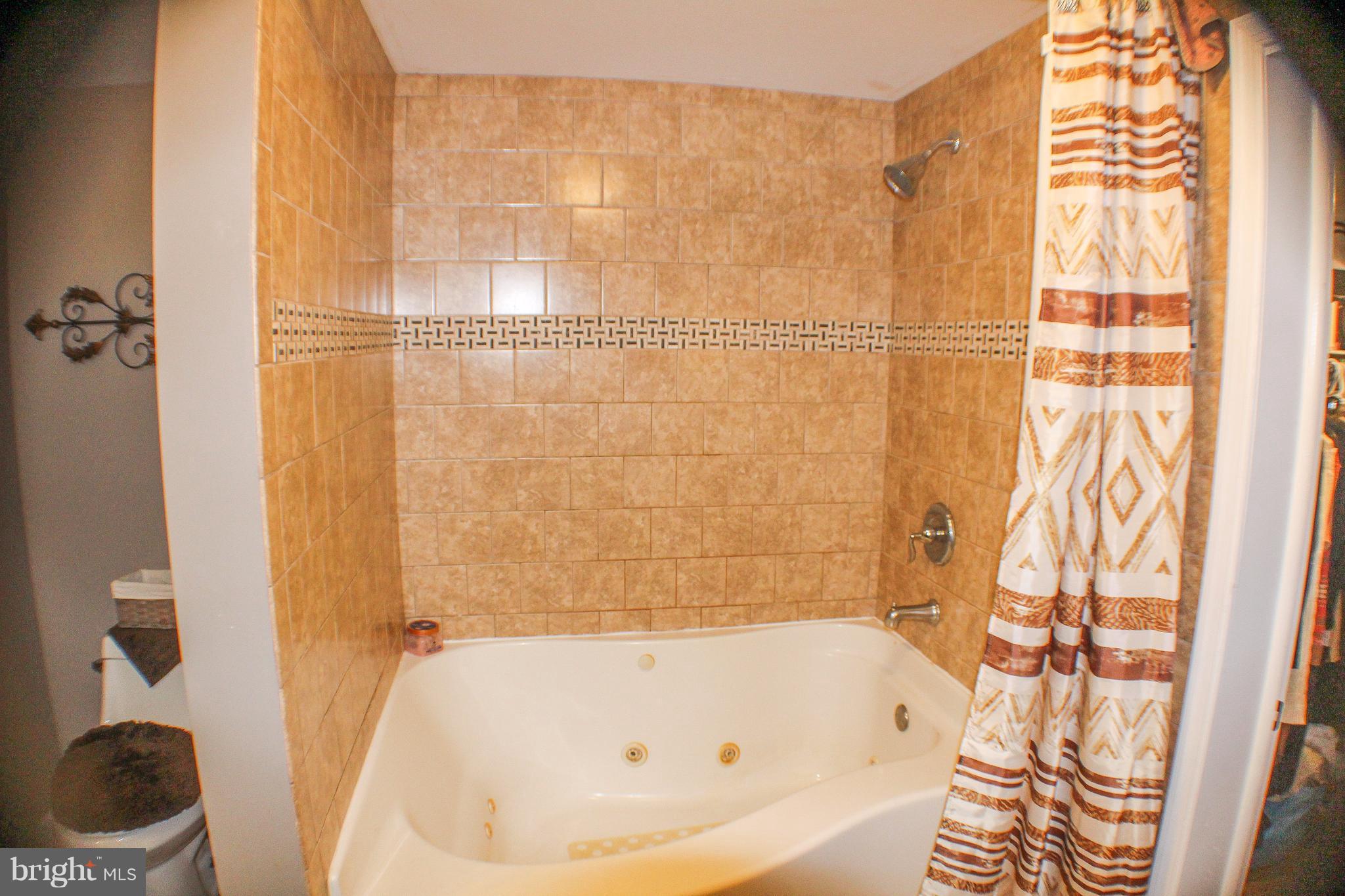 4155 Smallwood Church Road Indian Head, MD 20640 - Photo 19 of 30 a bathroom with a bathtub and a shower