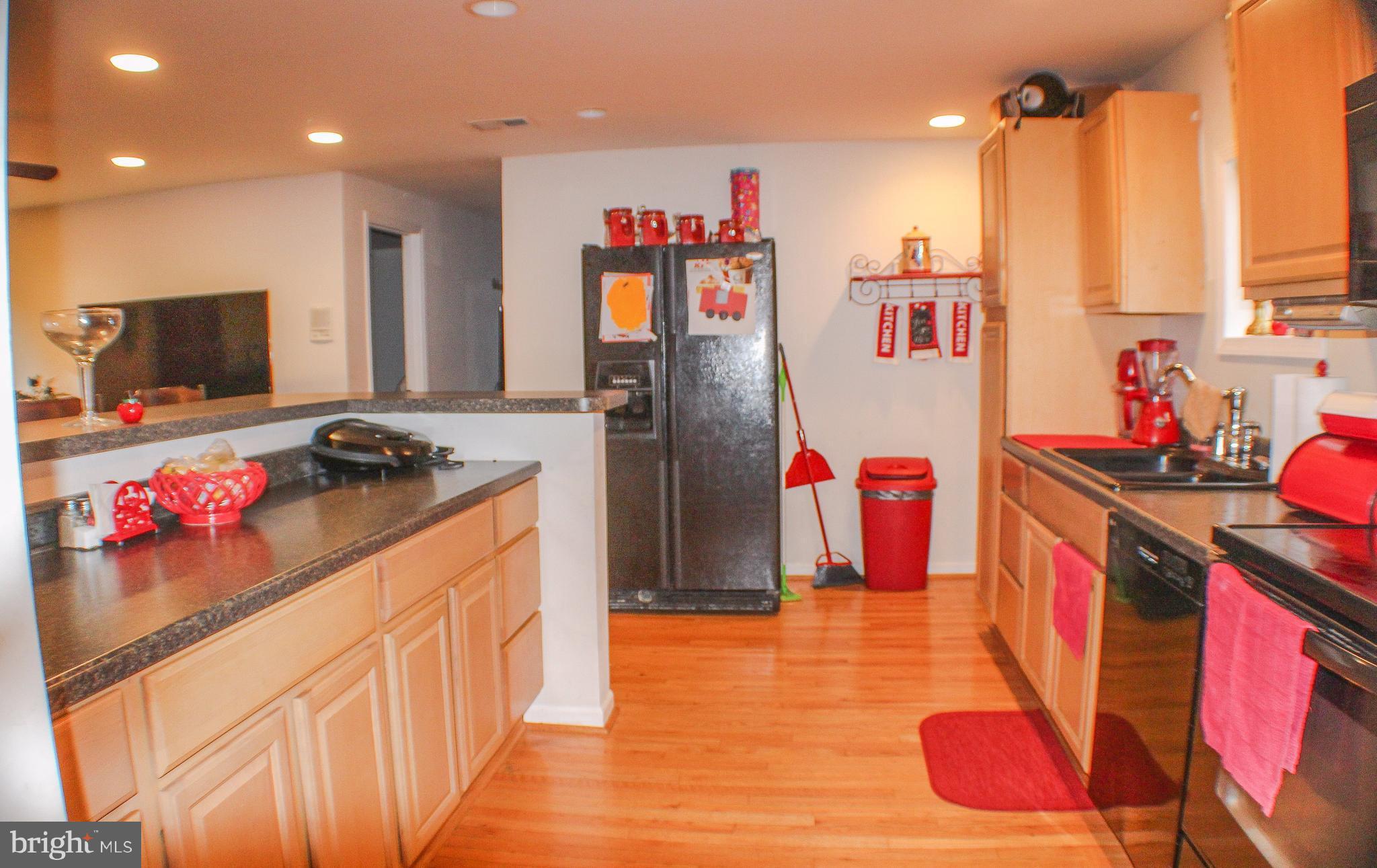 4155 Smallwood Church Road Indian Head, MD 20640 - Photo 6 of 30 a kitchen with stainless steel appliances granite countertop a stove a sink and a refrigerator
