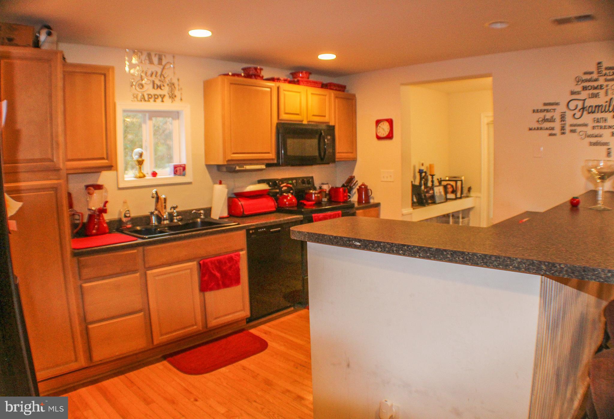 4155 Smallwood Church Road Indian Head, MD 20640 - Photo 7 of 30 a kitchen with stainless steel appliances granite countertop a sink stove and refrigerator